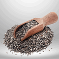 Wooden scoop filled with chia seeds on a light gray background